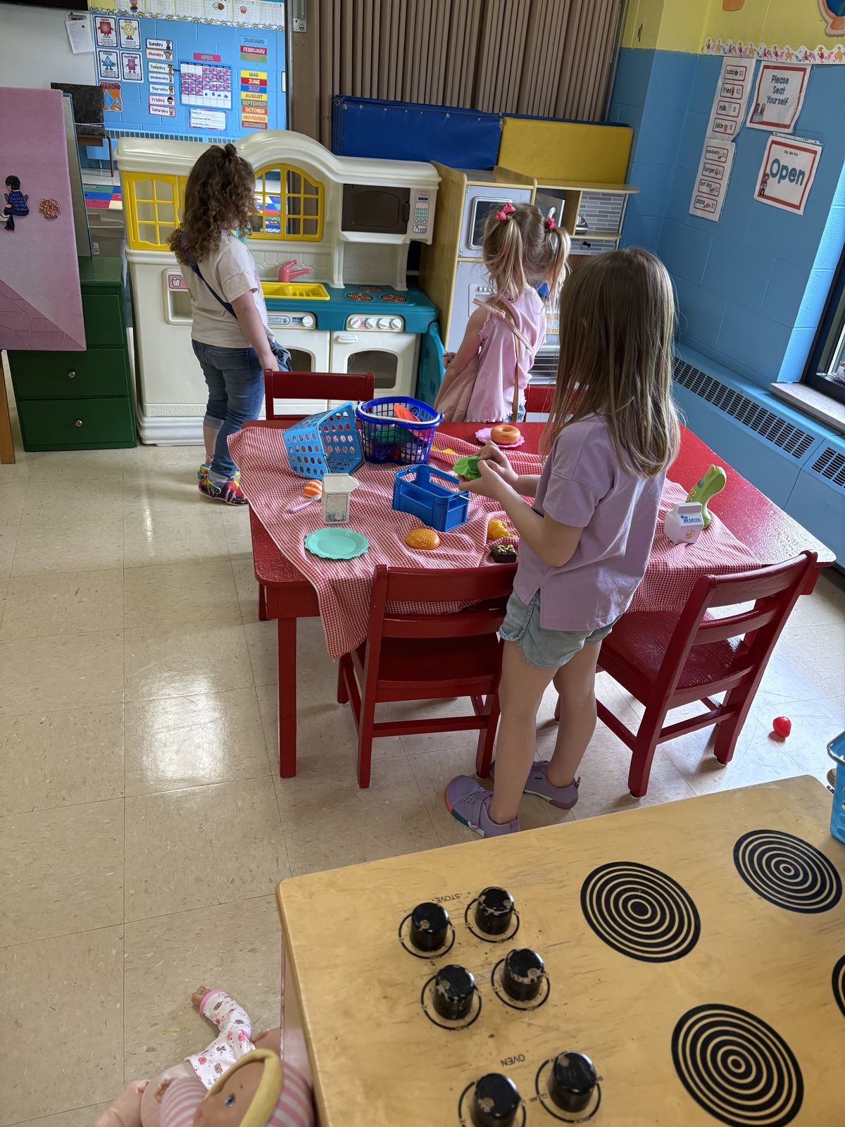 Children playing in the pretend kitchen area at Noah's Ark Preschool